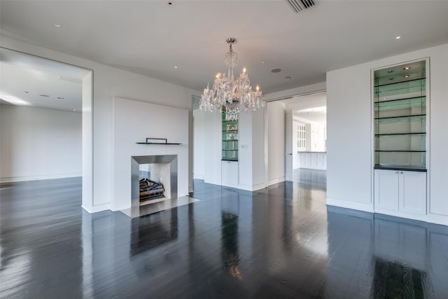 living area with visible vents, a fireplace, baseboards, and wood finished floors