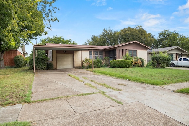 view of front of home with a front yard, an attached garage, concrete driveway, a carport, and brick siding