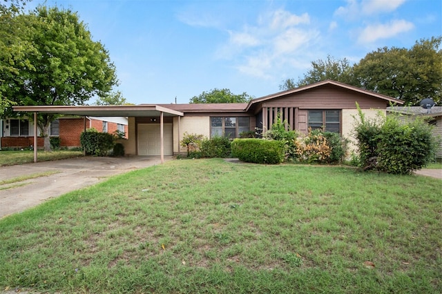 ranch-style home featuring an attached carport, a front yard, an attached garage, concrete driveway, and brick siding