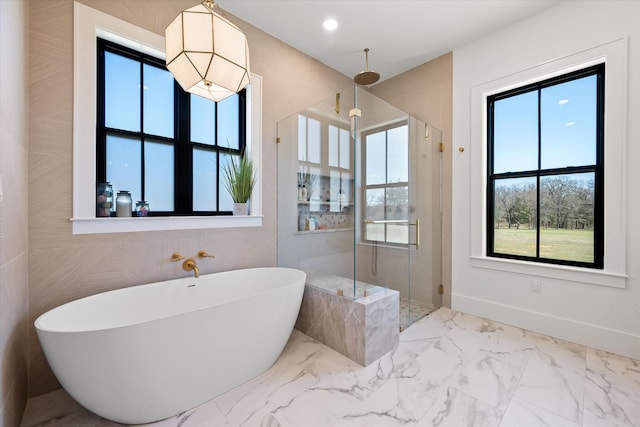 bathroom with a freestanding tub, marble finish floor, a stall shower, recessed lighting, and baseboards