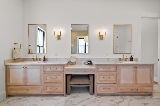 bathroom featuring double vanity, marble finish floor, and a sink