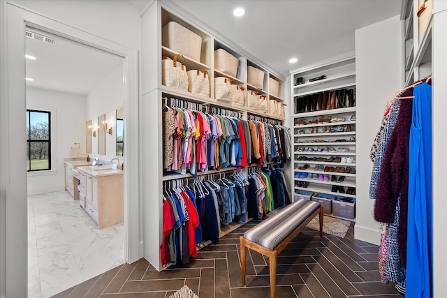 walk in closet featuring visible vents and marble finish floor