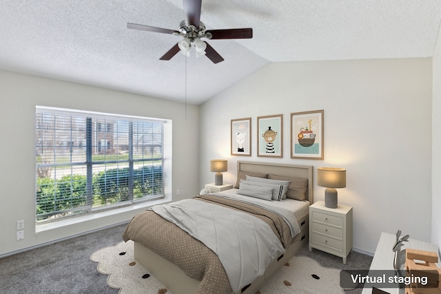 bedroom featuring carpet flooring, a textured ceiling, lofted ceiling, and a ceiling fan