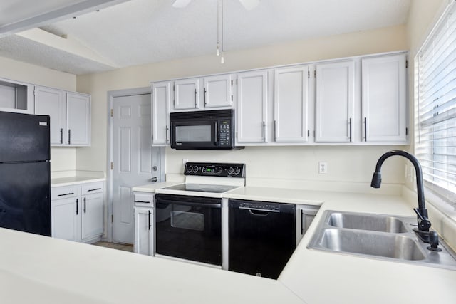 kitchen featuring a textured ceiling, black appliances, light countertops, and a sink