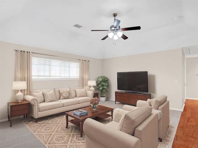 living room with visible vents, baseboards, lofted ceiling, and a ceiling fan