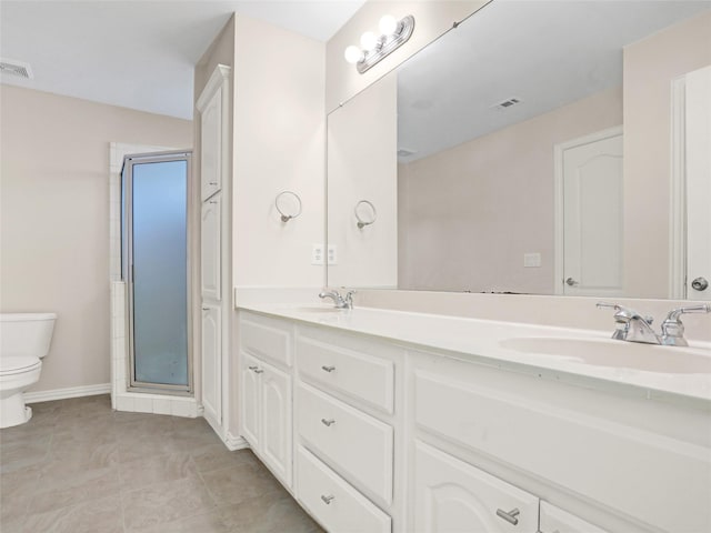 full bathroom with a sink, visible vents, toilet, and double vanity