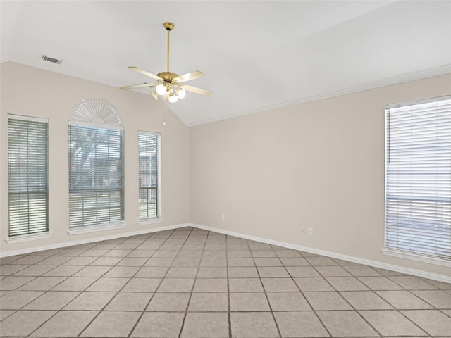 empty room featuring lofted ceiling, visible vents, a wealth of natural light, and ceiling fan