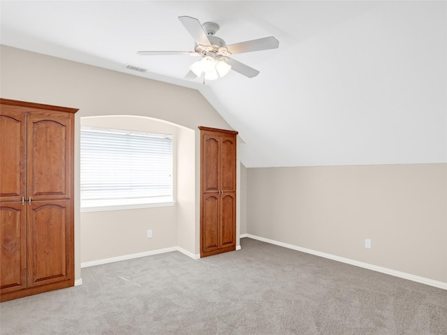 bonus room with visible vents, baseboards, light colored carpet, vaulted ceiling, and a ceiling fan