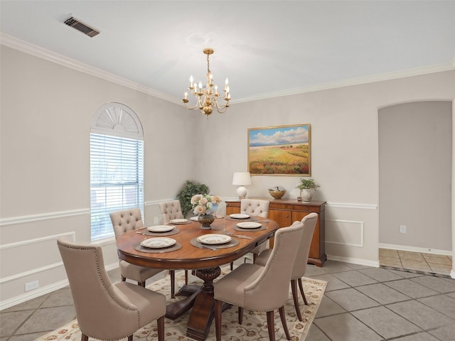 dining space featuring light tile patterned floors, visible vents, a notable chandelier, and ornamental molding