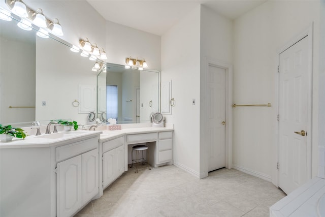 bathroom with vanity and baseboards