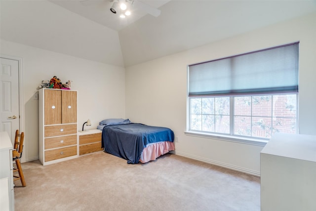 bedroom featuring baseboards, light colored carpet, a ceiling fan, and vaulted ceiling