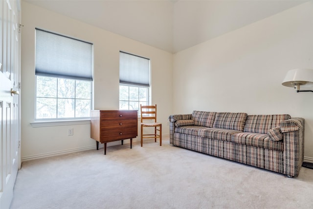 carpeted living area featuring baseboards