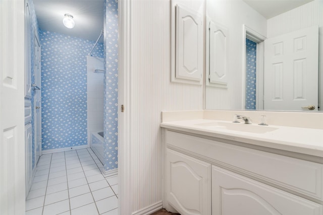 full bath featuring tile patterned floors, wallpapered walls, baseboards, bathtub / shower combination, and vanity