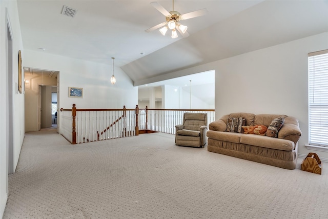 sitting room with a wealth of natural light, carpet floors, ceiling fan, and vaulted ceiling