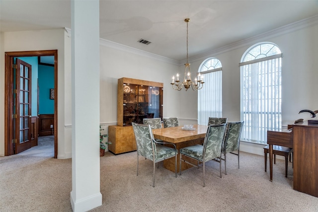 carpeted dining room with a chandelier, visible vents, baseboards, and ornamental molding