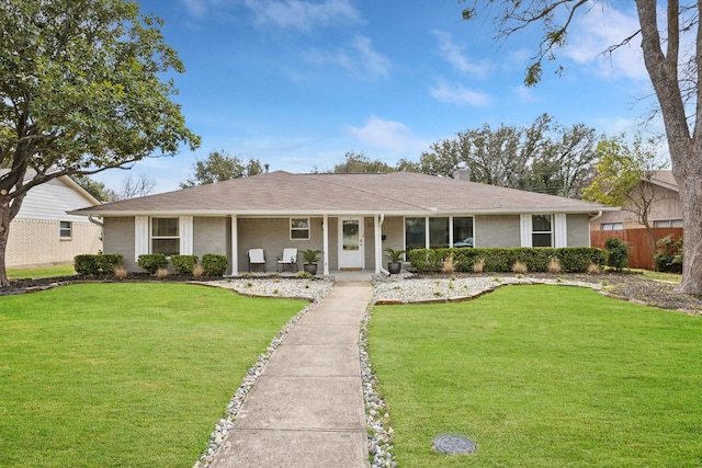 single story home with brick siding, a chimney, a front yard, and fence