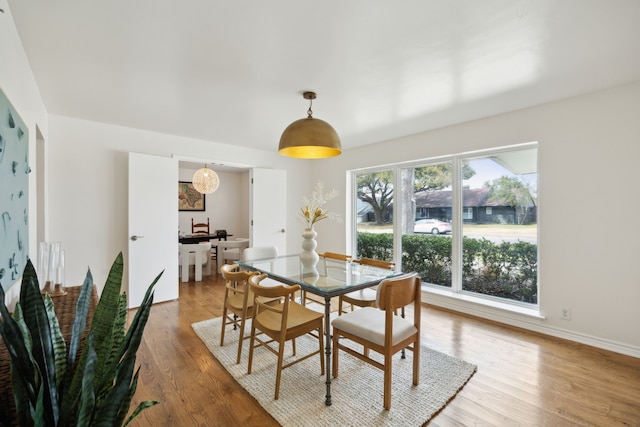 dining area featuring baseboards and wood finished floors