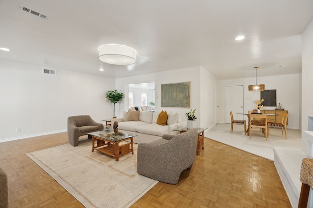 living room with recessed lighting, baseboards, and visible vents