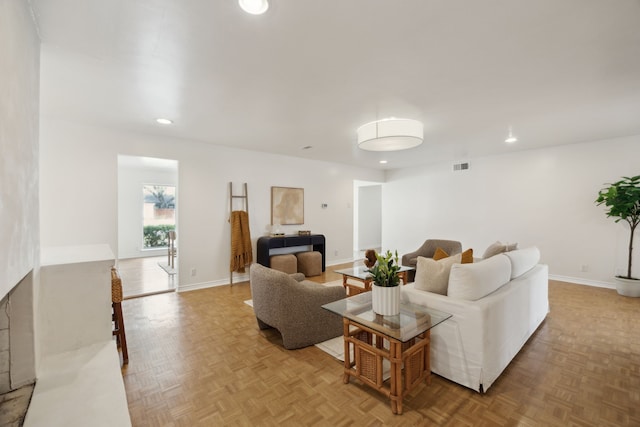 living room featuring recessed lighting, baseboards, and visible vents