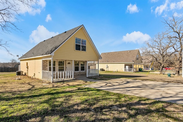 back of house with cooling unit, a lawn, a porch, and fence