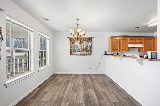 unfurnished dining area with visible vents, dark wood-type flooring, and baseboards