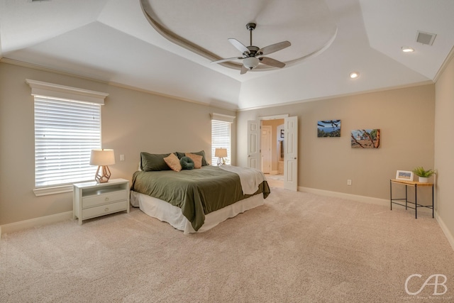 carpeted bedroom featuring a tray ceiling, multiple windows, visible vents, and ornamental molding