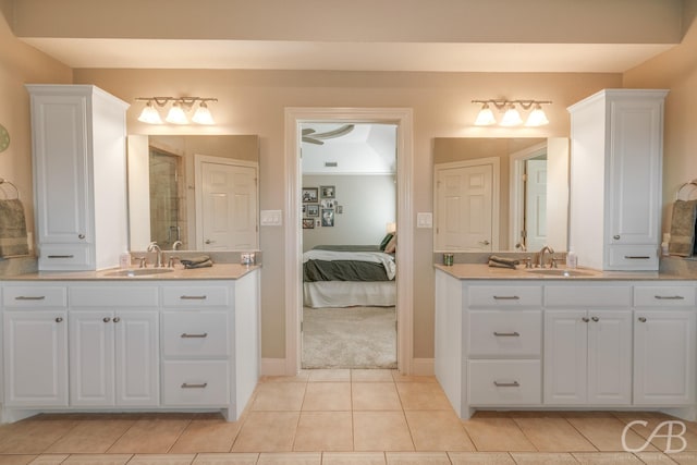 full bath featuring a shower stall, two vanities, and a sink