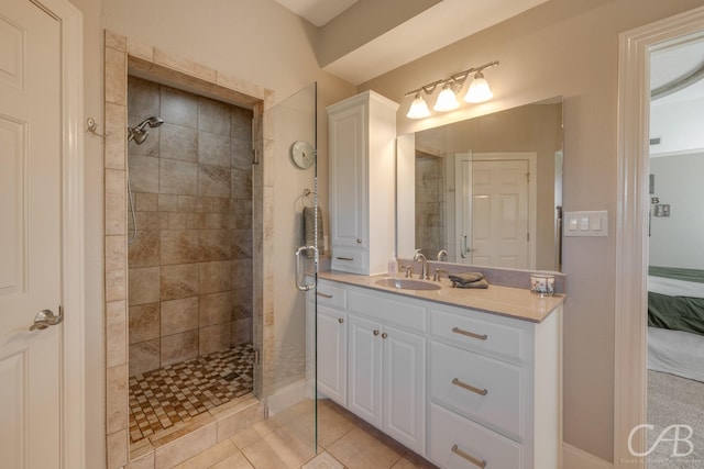 full bathroom with connected bathroom, tiled shower, vanity, and tile patterned flooring