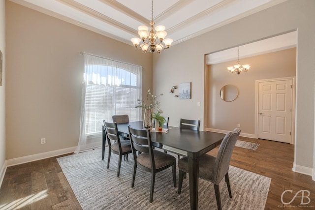 dining area with baseboards, a chandelier, a tray ceiling, ornamental molding, and wood finished floors