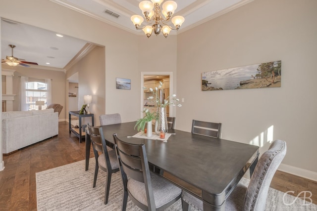 dining area with visible vents, ceiling fan with notable chandelier, wood finished floors, crown molding, and baseboards