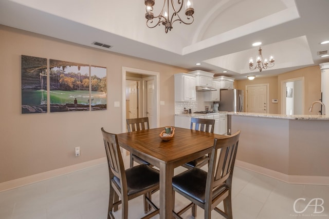 dining area with baseboards, visible vents, an inviting chandelier, recessed lighting, and a raised ceiling