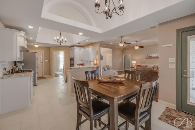 dining room featuring a tray ceiling, recessed lighting, and baseboards