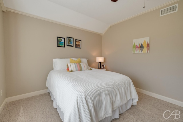 carpeted bedroom featuring visible vents, a ceiling fan, baseboards, crown molding, and lofted ceiling