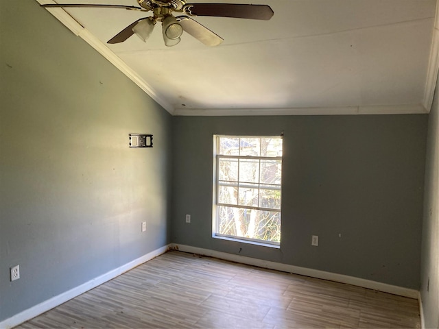 unfurnished room with vaulted ceiling, baseboards, and ornamental molding