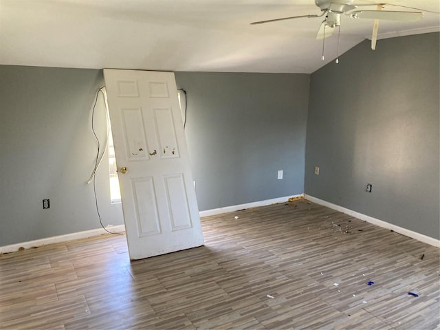 empty room with a ceiling fan, wood finished floors, and baseboards