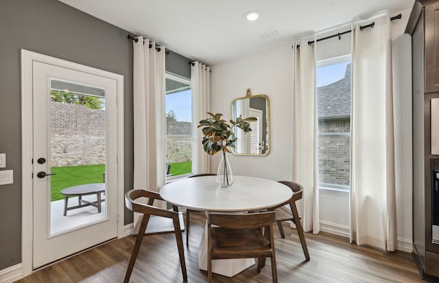 dining space with visible vents, baseboards, and light wood-style floors