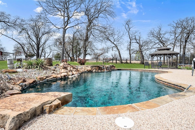 pool featuring a gazebo and fence