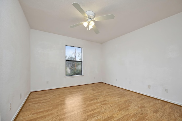 unfurnished room featuring light wood-type flooring and ceiling fan