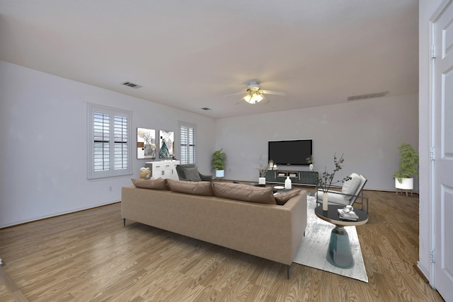 living area featuring visible vents, light wood-type flooring, and ceiling fan