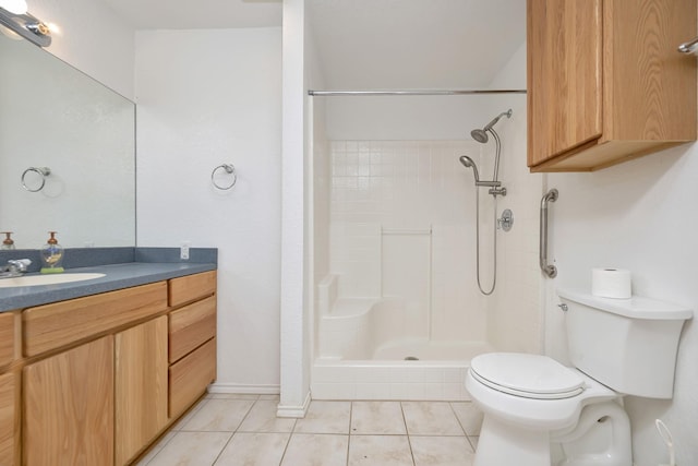 full bath featuring vanity, tile patterned floors, toilet, and tiled shower