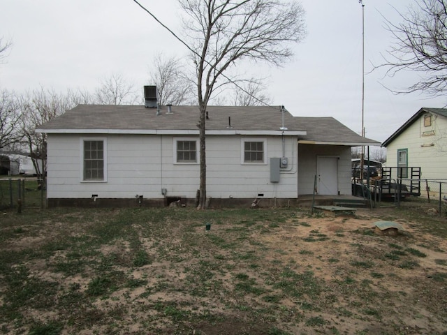 rear view of house with crawl space and fence