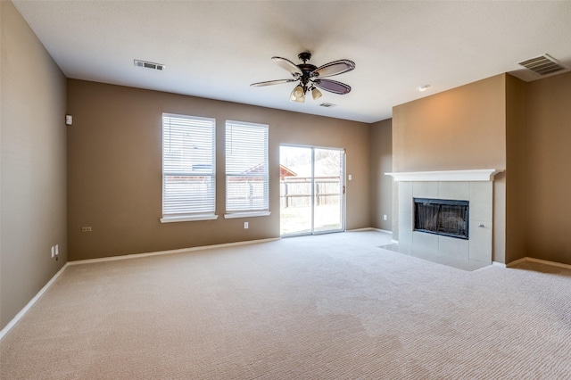 unfurnished living room featuring visible vents, carpet flooring, a fireplace, and ceiling fan