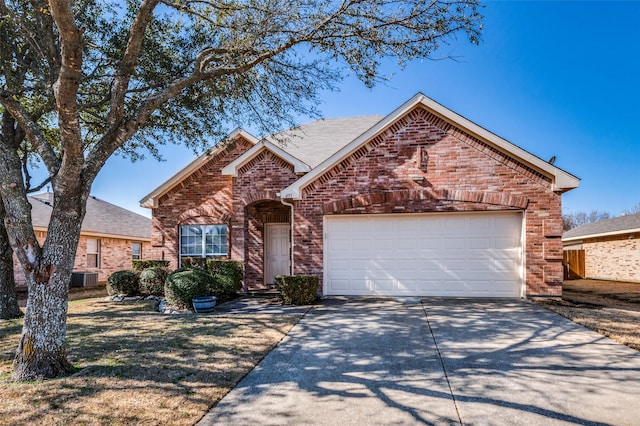 view of front facade with brick siding, driveway, an attached garage, and central AC