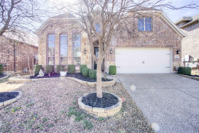 view of front of property with stone siding, brick siding, an attached garage, and driveway