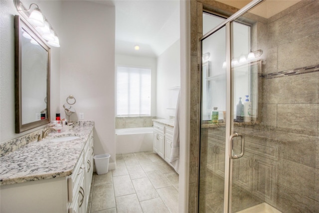 bathroom featuring a bath, tile patterned flooring, a shower stall, and vanity