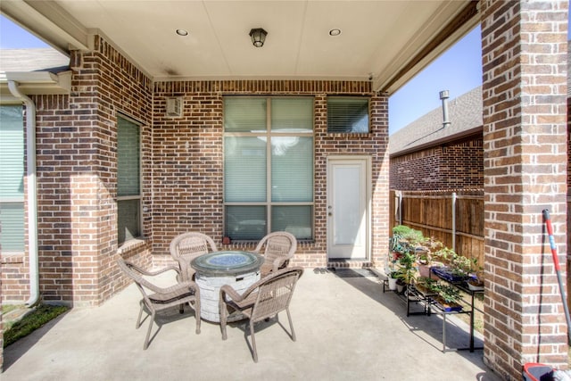 view of patio / terrace with an outdoor fire pit and fence