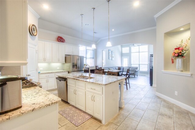 kitchen with ornamental molding, a sink, appliances with stainless steel finishes, white cabinetry, and tasteful backsplash