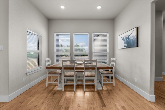 dining room with recessed lighting, baseboards, and light wood-type flooring