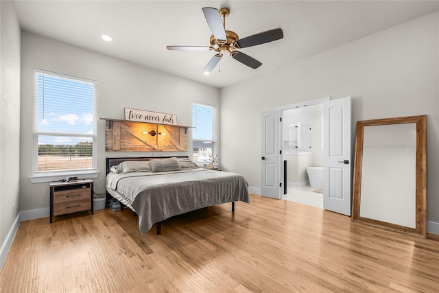 bedroom featuring connected bathroom, baseboards, light wood-style floors, and ceiling fan