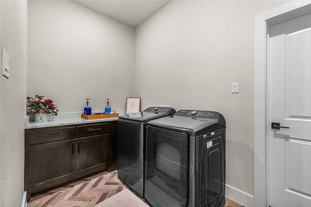 laundry room with washer and dryer, cabinet space, and baseboards